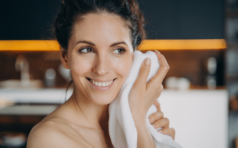 woman drying her face with towel