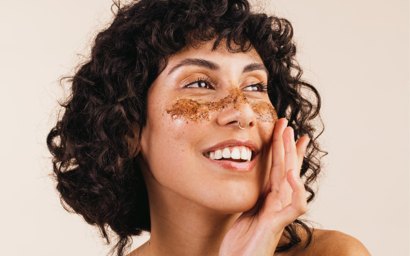 woman exfoliating her face