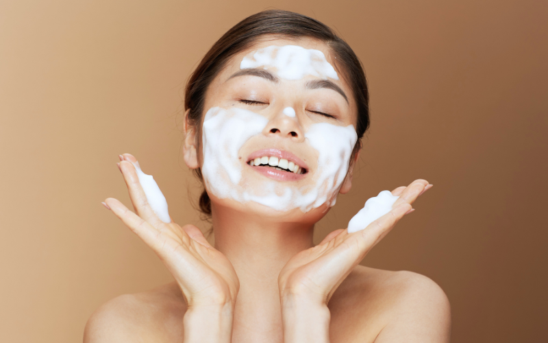 woman applying soap to face