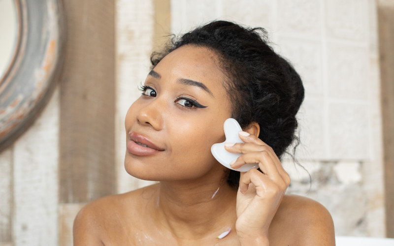 girl massaging gua sha on face