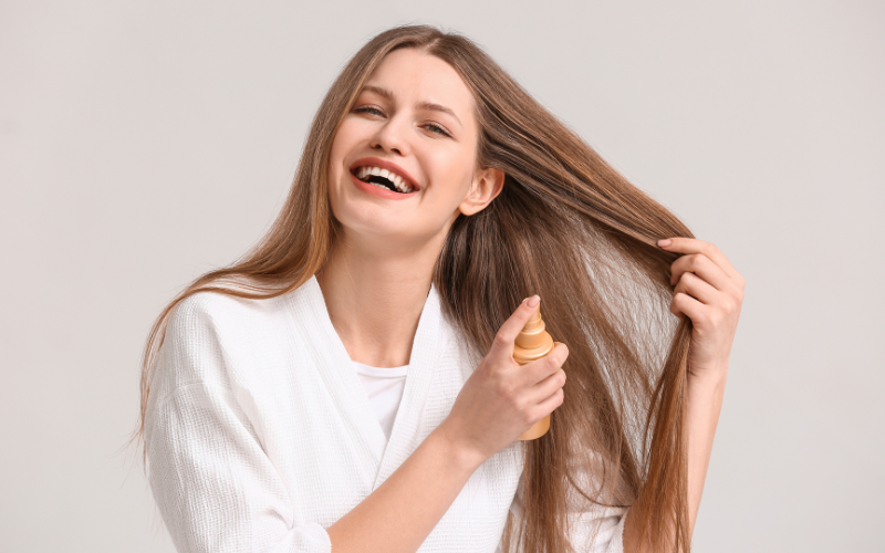 girl applying Hair Sprays