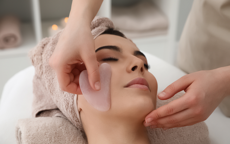 girl massaging gua sha on face