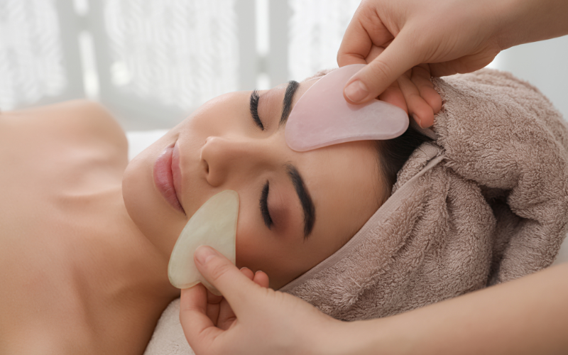 girl applying Gua Sha on face