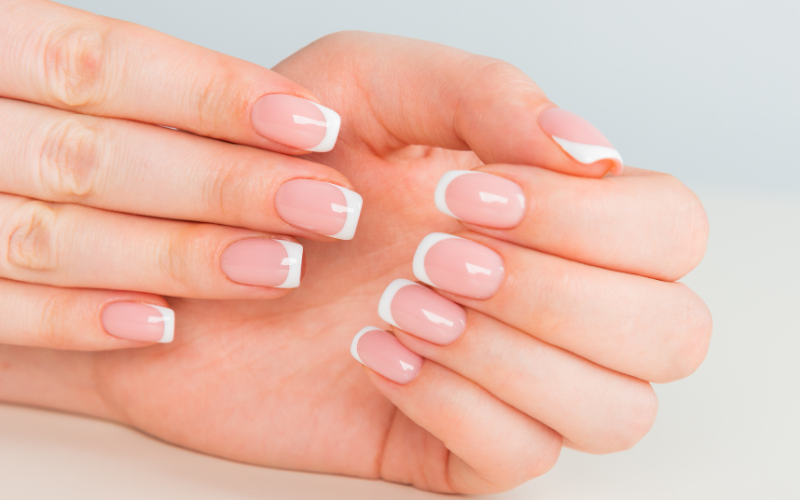 girly hands with gel poslish and white nail art tips