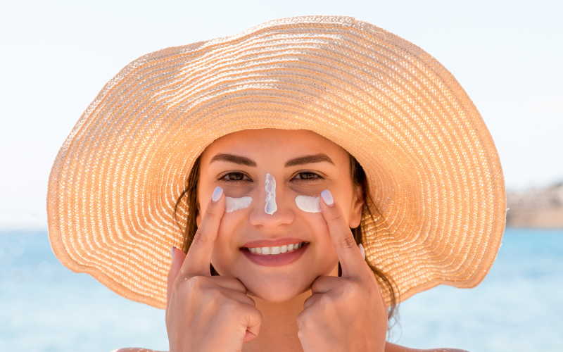 girl applying Sunscreen on face