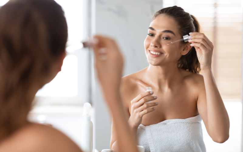 girl applying Tea Tree Oil on face