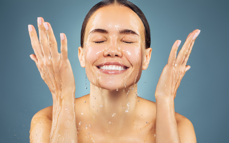 girl splashing water on face