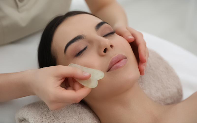 girl massaging gua sha on face