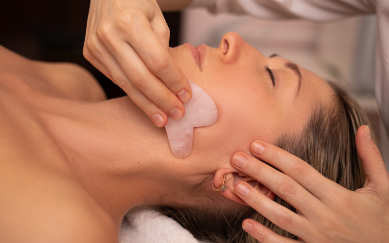 girl massaging gua sha on face