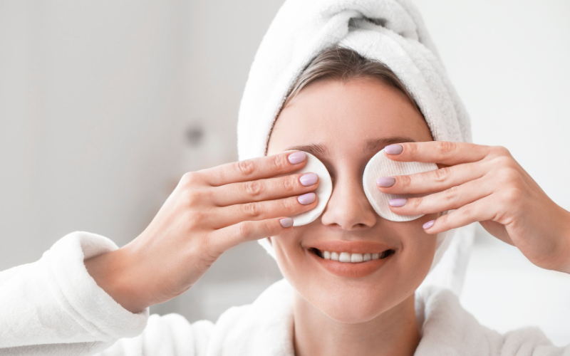 girl cleaning her makeup with cotton makeup remover pads