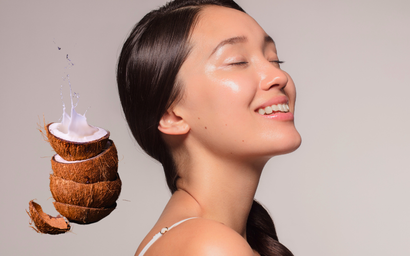 woman eyes closed looking up, coconut on left