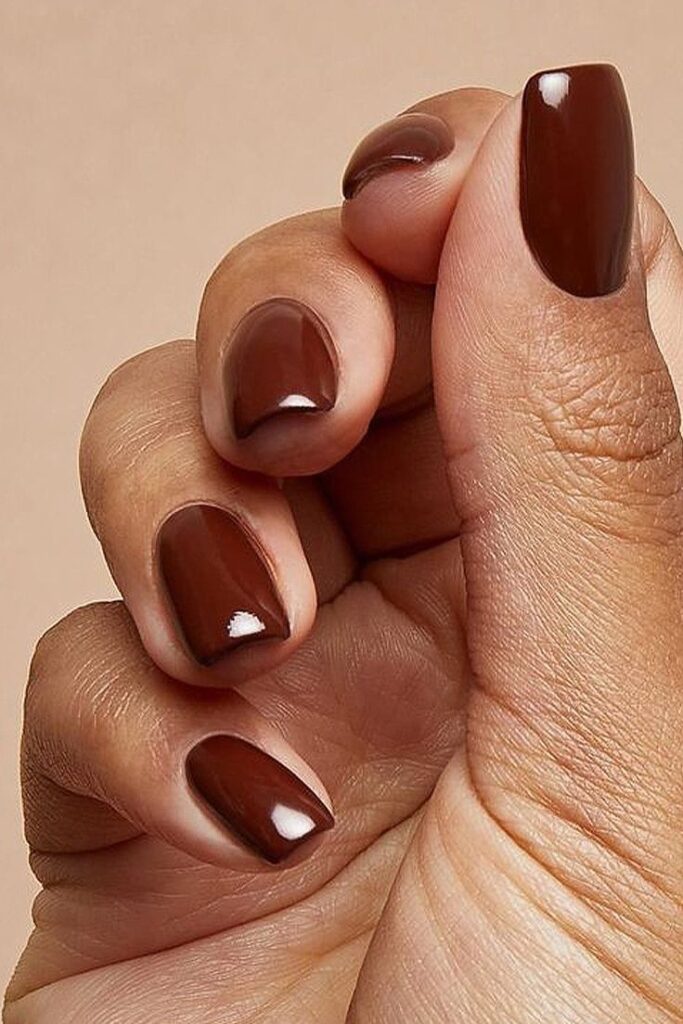 A stunning fall-inspired nail art design featuring a warm, earthy color palette on dark skin.