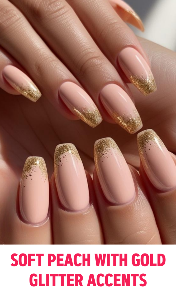 Soft peach nails with a touch of gold glitter on the tips