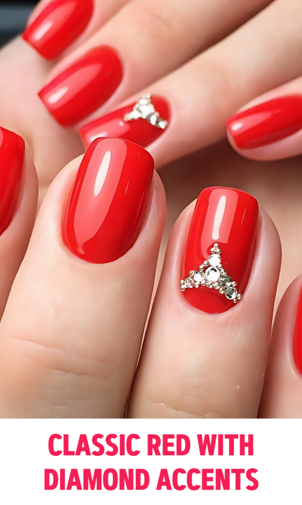 Glossy red nails with diamond accents on each ring finger