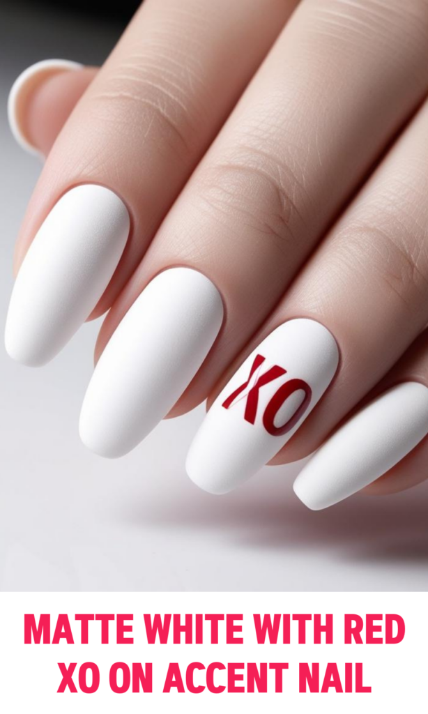 Matte white nails with a single XO in red