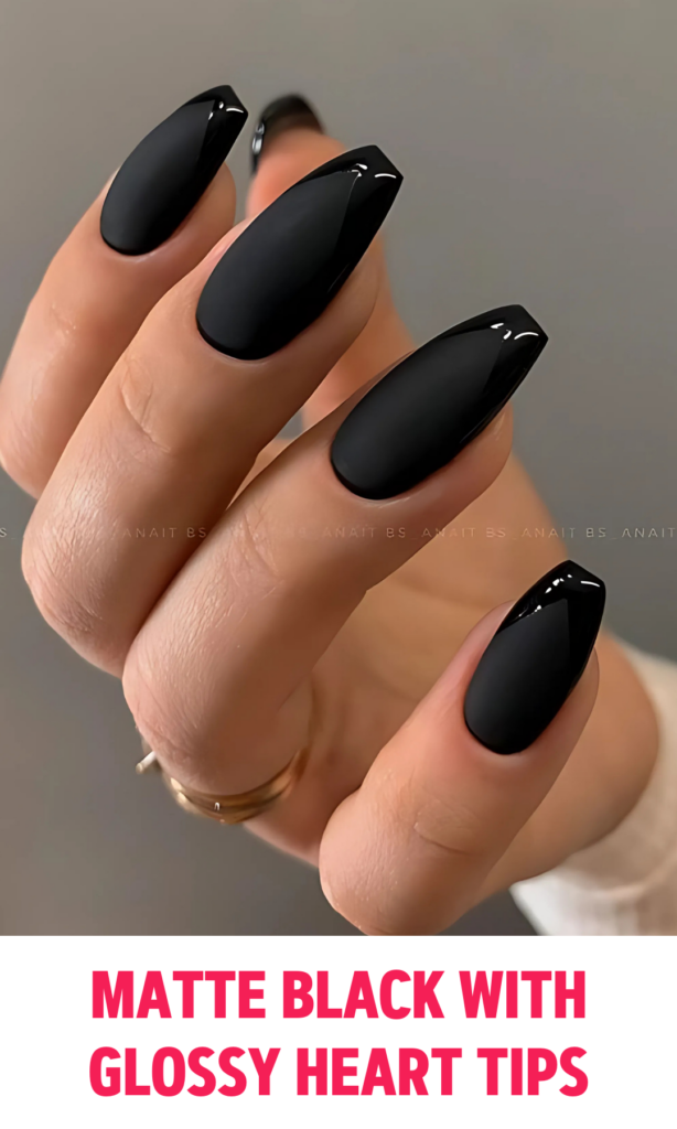 Matte black nails with glossy black heart-shaped tips